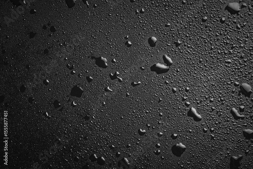 Drops of water on a black surface. The condensate. Top view. Free space.