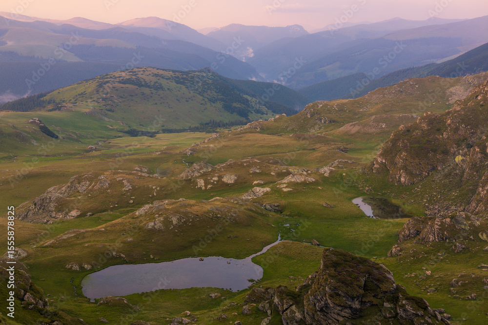 Obraz premium The Carpathian Mountains in Romania are a majestic mountain range, rich in wildlife, forests, and breathtaking landscapes.
