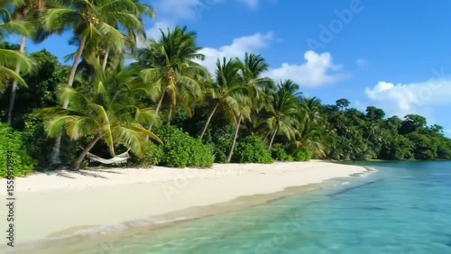 Tropical paradise beach with palm trees and hammock under blue sky