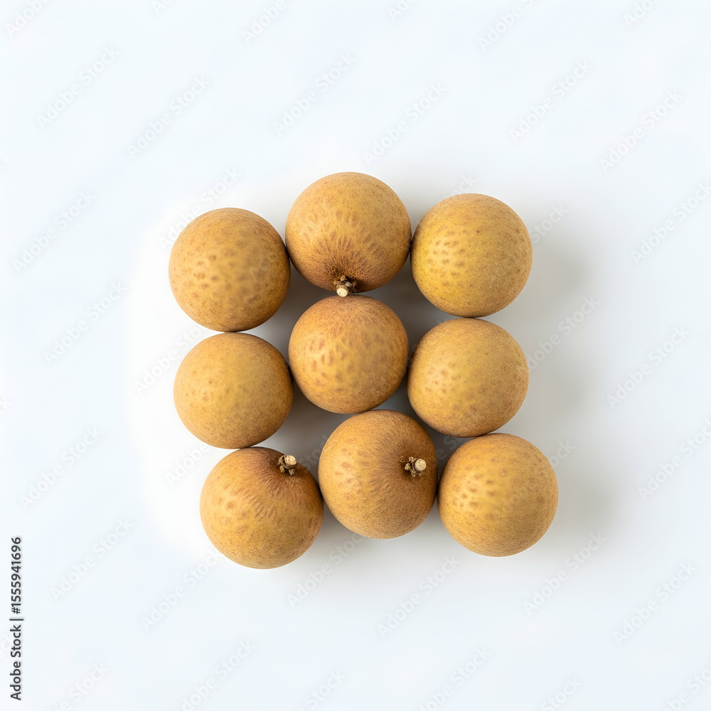 Fresh longan fruits arranged on a clean white surface, showcasing their delicious texture and natural beige color. Fresh longan fruits arranged on a clean white surface, showcasing their delicious texture and natural beige color.