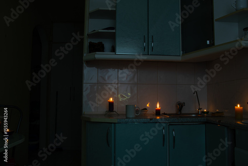 Kitchen by candlelight during power outage - coziness in the dark, candles on the countertop, blackout in the house