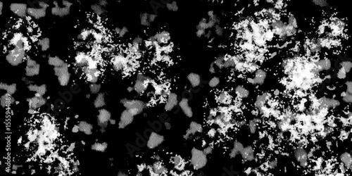 Snowflakes on dark background. white icy snowflakes isolated on black background, natural background. white crystalline powder on a black background. sugar dust. texture, pattern and clipping.
