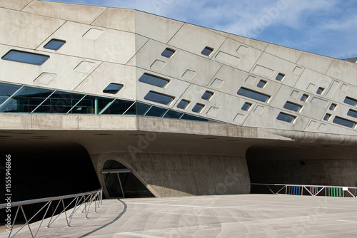 Canvastavla Modern concrete building with geometric asymmetrical windows and futuristic design