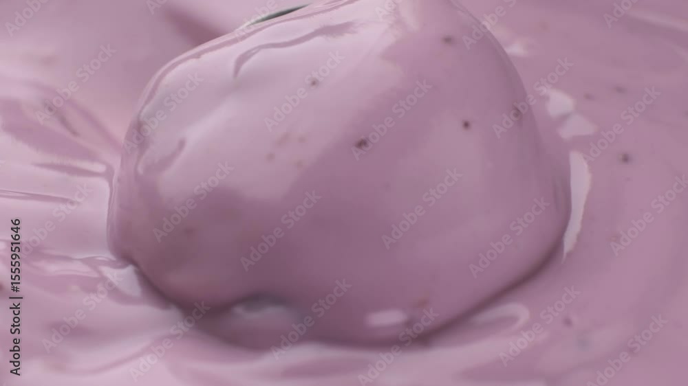 Close-up spoon scooping berry yogurt from package, fresh and creamy dessert Close-up spoon scooping berry yogurt from package, fresh and creamy dessert
