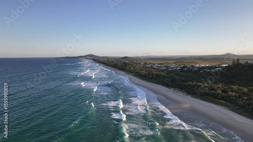Sunset Drone Flyback Over Sunshine Beach with Ocean Waves and Coastal Bushland