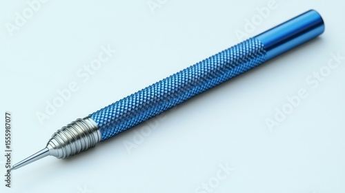 Blue metallic precision tool, pointed tip, textured shaft