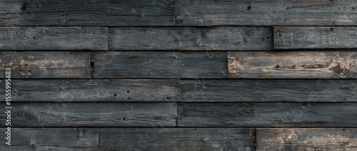 Dark, horizontally-laid reclaimed wood planks showing age, texture, and variations in tone