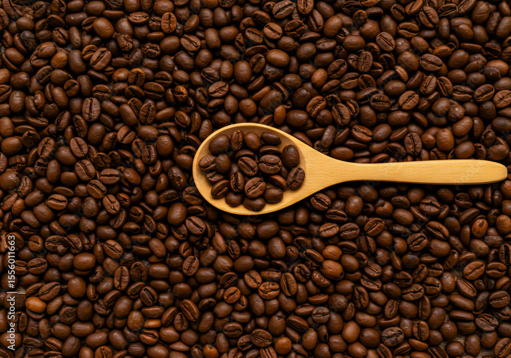Obraz premium Coffee Beans Texture with Wooden Spoon