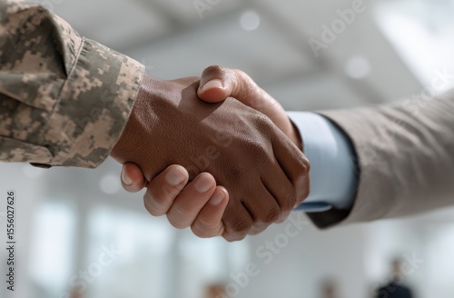A soldier and a businessman shake hands, symbolizing a strong partnership forged between military service and civilian life.