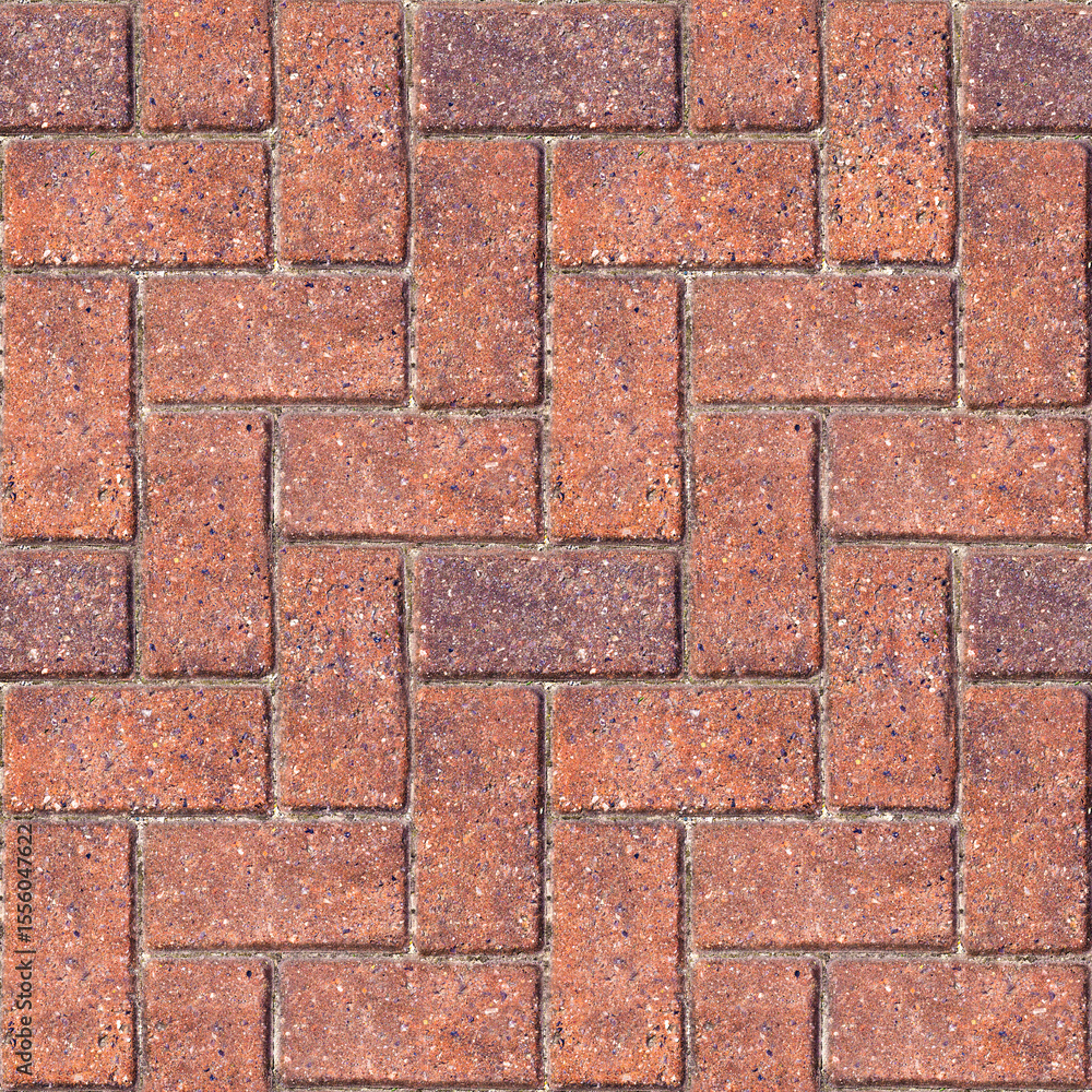 Obraz premium Brick herringbone pattern - Repeating masonry paving typically found in developed areas. Often seen in towns, patios and driveways. Seamless background texture to tile with brown color.