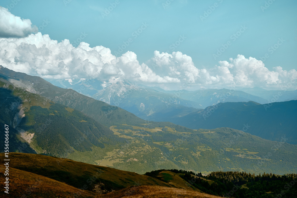 Obraz premium Mountain ranges on a sunny day at Georgia. Sky with clouds adn hills