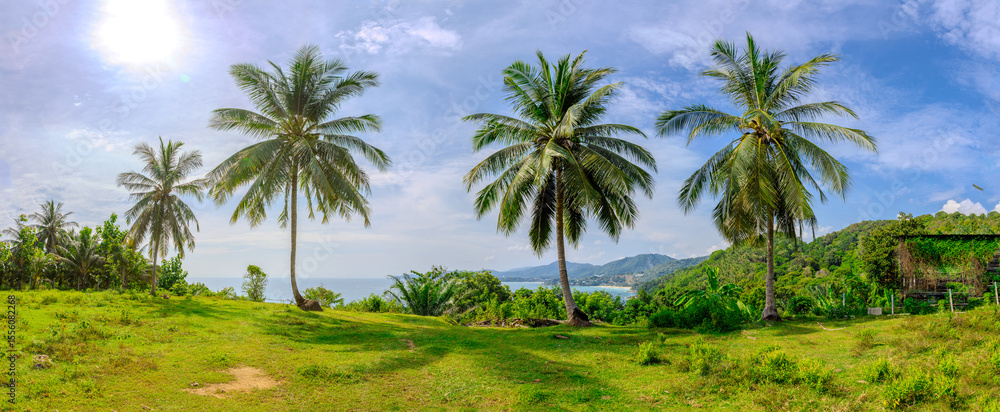 Obraz premium Views through lush green trees and palms over looking Kata and Kata Noi on the beautiful island of phuket in Thailand with lush green mountains and turquoise blue waters of the Andaman Sea