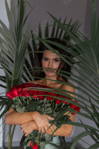 Wallpaper Mural beautiful mulatto woman with a large bouquet of scarlet roses Torontodigital.ca