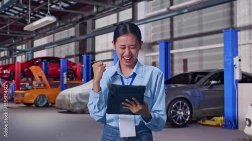 Wallpaper Mural Asian Female With Her Tablet in Auto Repair Shop, She Raises Her Fist Up With Screaming Goal Torontodigital.ca