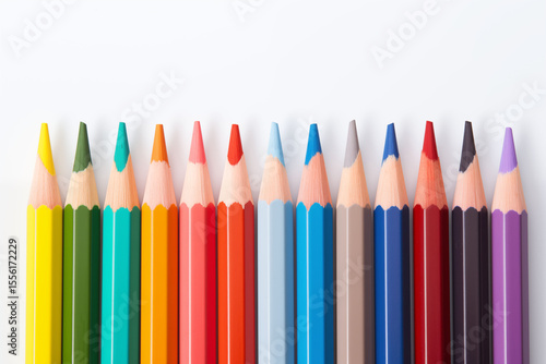 Multicolored pencils arranged in a straight line on a white background.