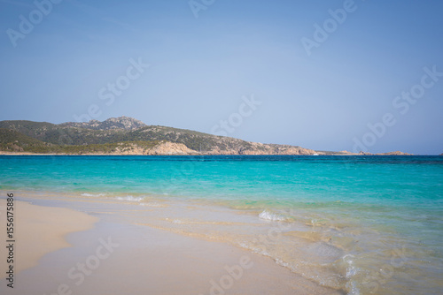 A beach with turquoise waters on the island of Sardinia.