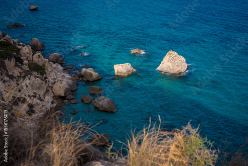 An area of rocks and cliffs with turquoise waters on the island of Sardinia.