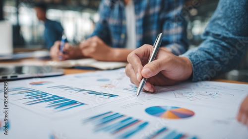 Business Professionals Analyzing Charts and Graphs in Office Setting
