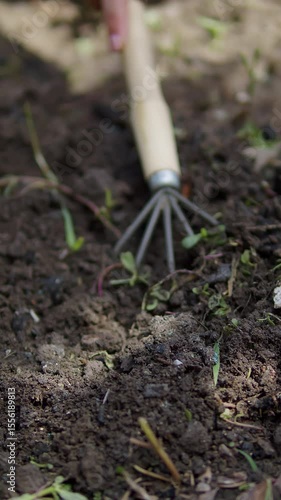 Garden cultivator loosening soil close up