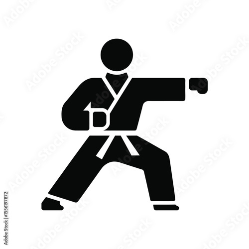 Karate fighter in a black gi performing a punch in a fighting stance