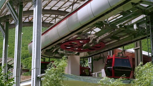 In summer, take funicular ride, cable car ride, scenic tourist trip. Green forest, bright sunny day, blue sky with clouds