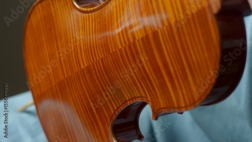 Obraz na plátně Skilled craftsman applying protective varnish to violin body, highlighting intri