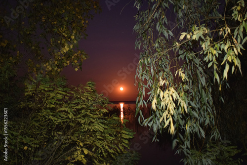 Moon is rising up the river. Moon road