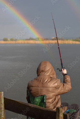 Fishing in the lake against rainbow