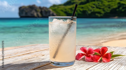 Refreshing Tropical Cocktail on Beachside Table with Flowers and Ocean View