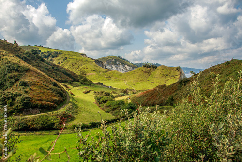 Landscape of rocky beach with hills, mountains and Atlantic Ocean coast of northern Spain, against sky