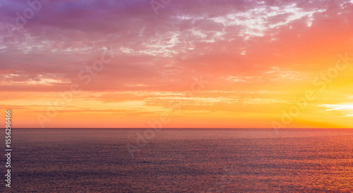 Fototapeta Naklejka Na Ścianę i Meble -  beautiful sunrise or sunset seascape with amazing calm sea water with waves and colorful amazing cloudy morning sky on background