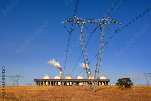 High voltage electricty pylon in front  of the Kusile coal power station with the dry cooling unit in front of it