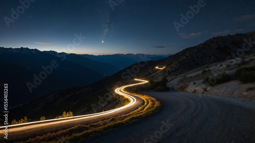 Curving Mountain Road Illuminated at Night With Stars in the Background and a Planet Visible in the Sky