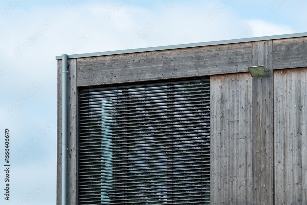 Fototapeta premium Modern wooden building exterior with venetian blinds and led light