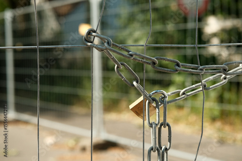 padlock on a fence around a construction site