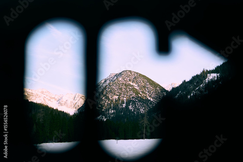 Capturing a stunning alpine view through a unique perspective in the Alps during late afternoon