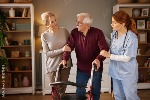 Foto An elderly man uses a walker for mobility in a living room, with his wife and a home care nurse assisting him