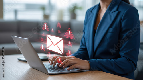 Businesswoman receives alarming email notifications while working on laptop