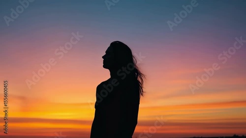 Silhouette of person against colorful sunset or sunrise sky