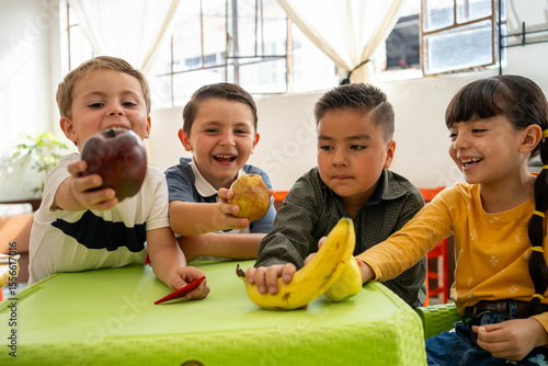 Smiling kindergarten kids show off their fruits in preschool class. A fun and colorful moment that highlights healthy habits and food learning through play.