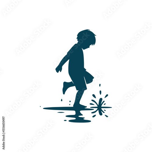 A playful boy splashing in a puddle