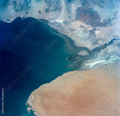 Aerial view of the Shatt al Arab River delta along the Persian Gulf, showing sediment patterns and coastal landforms. Image courtesy of NASA.
