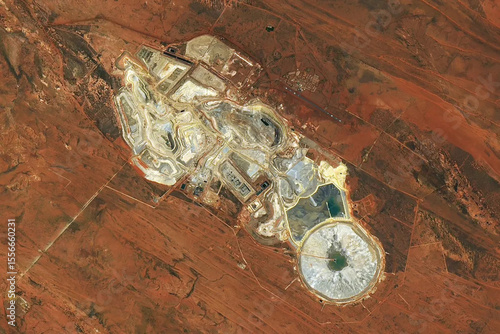 фотографія A satellite view of the Telfer gold and copper mine in Western Australia, showing terraced open-pit operations and tailings ponds
