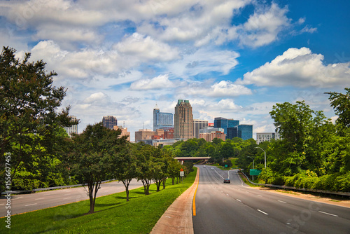 A highway skyline leading into the capital city Raleigh North Carolina on a nice cloudy day in summer.