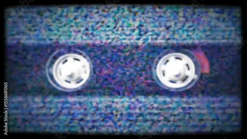 A close-up view of a vintage VHS tape showing a colorful glitch effect