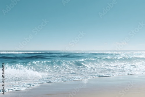 Gentle sea waves on sandy beach with blue sky