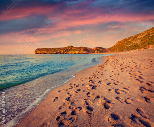 Fototapeta Naklejka Na Ścianę i Meble -  Footprints in the sand on Patara beach, turkey, District of Kas, Antalya Province, Asia. Amazing summer sunset in Turkish resort. Vacation concept background.