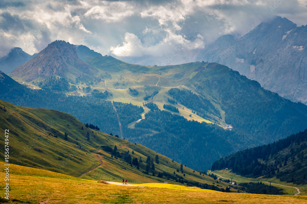 Fototapeta premium Trekking in Dolomite Alps. Picturesque summer scene of Sella - high mountain pass within the Dolomites features sweeping views. Long focus picture of dramatic mountains valley, Italy, Europe.