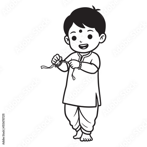 A smiling young boy wearing traditional indian clothes with a rakhi bracelet