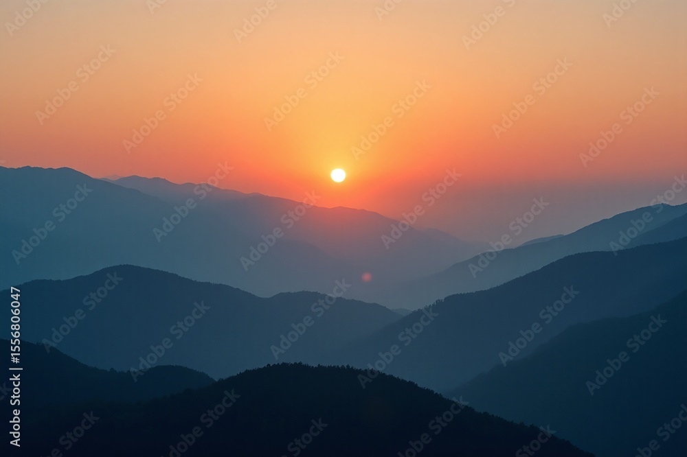 Fototapeta premium Sunrise Over Misty Mountain Layers with Warm Tones